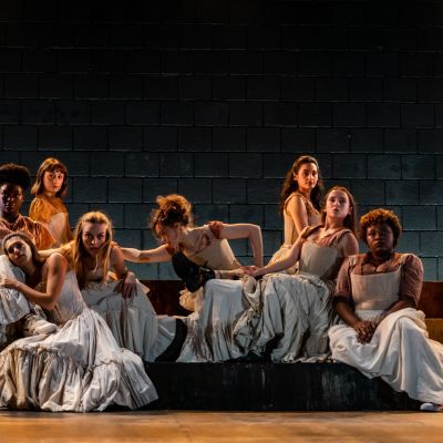 Group of actors on stage in period costume